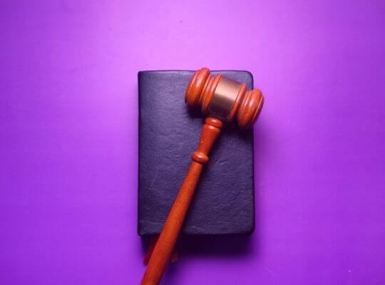law hammer with purple bg | DYS Law Group